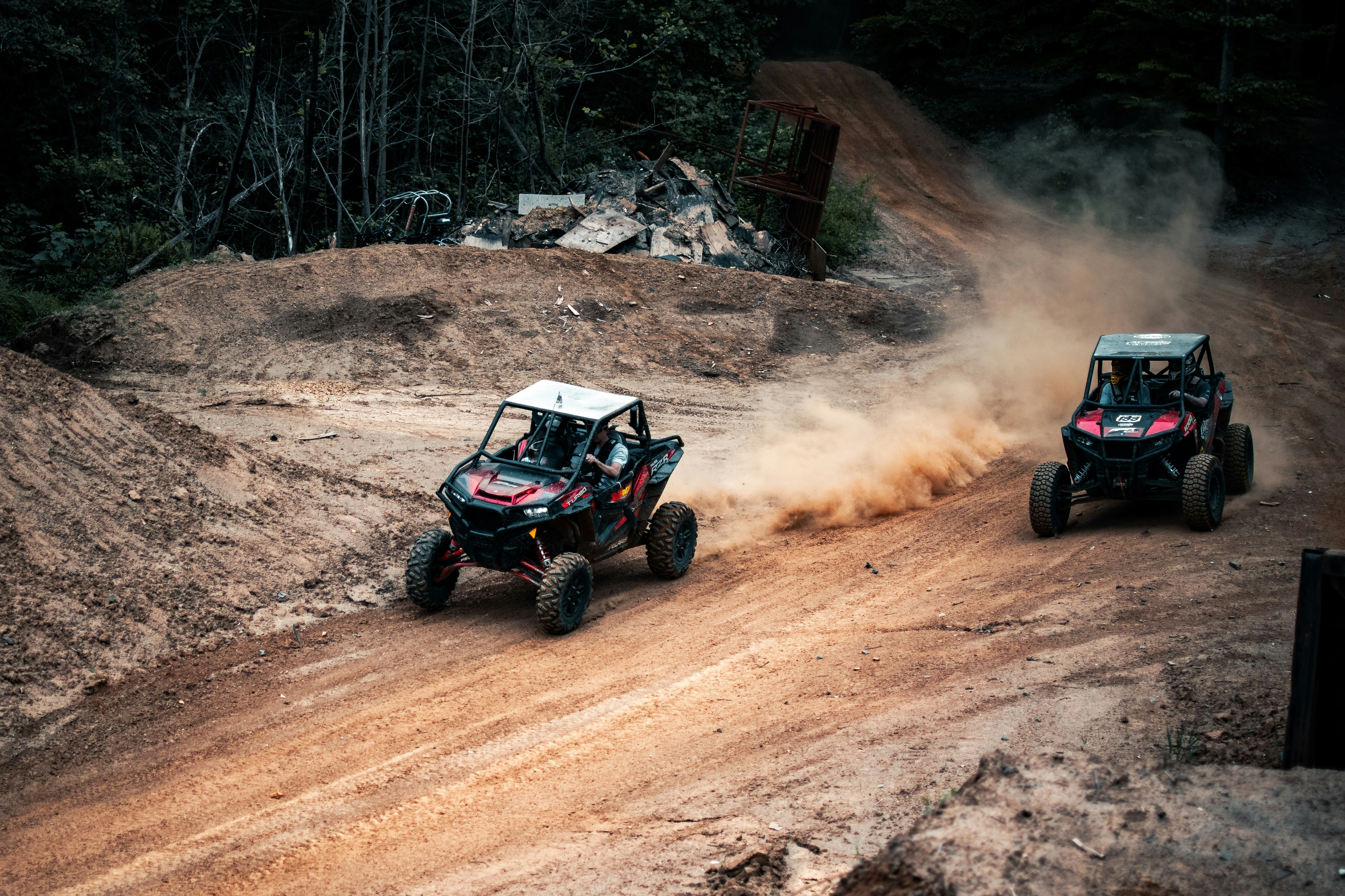 black and red atv on brown dirt road during daytime